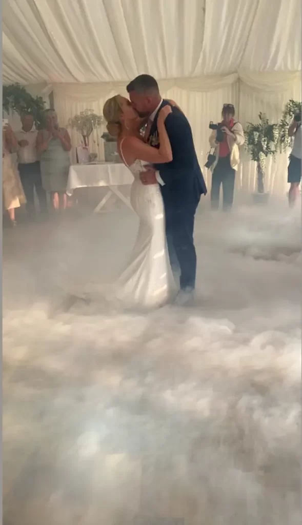 Bride and groom dancing on the clouds